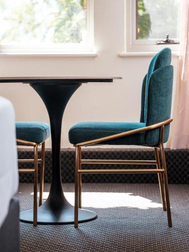 two chairs and a table in a room at Lenna Of Hobart in Hobart