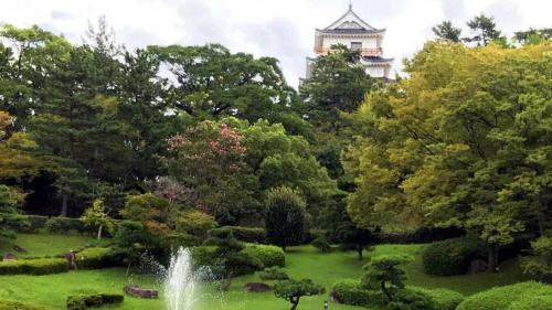a park with a fountain and a tower in the background at Toyoko Inn Fukuyama-eki Shinkansen Minami-guchi in Fukuyama