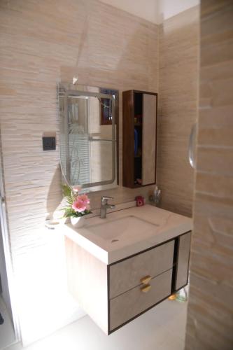 a bathroom with a sink and a mirror at Villa KN in Ambalangoda
