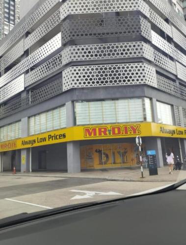 a large building with a yellow sign in front of it at The Luxe Sanctuary in Southville City in Bangi