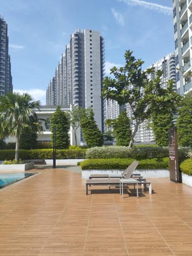a park with a bench and a table and buildings at The Luxe Sanctuary in Southville City in Bangi