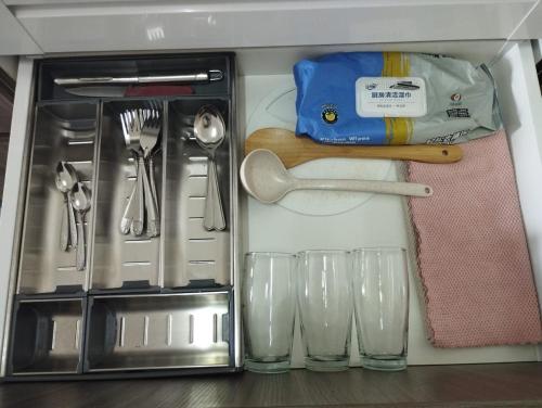 a drawer filled with utensils and glasses at The Luxe Sanctuary in Southville City in Bangi