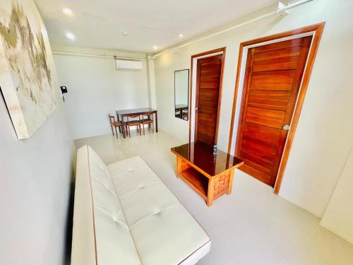 a living room with a white couch and a table at Hotel Elegant La Union in San Fernando
