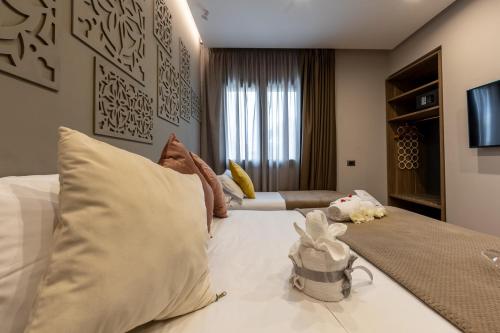 a bedroom with a white bed and a couch at Giafra Luxury Rooms in Agrigento