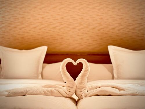 two swans making a heart on a bed at THE KAKU Exclusive suite & Residence in Nara