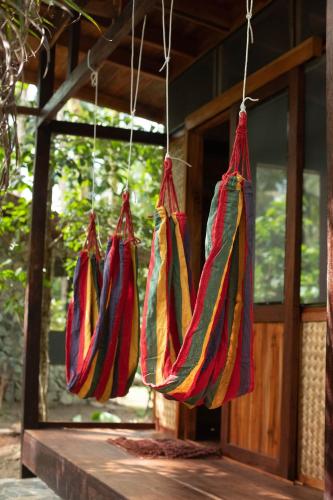 a group of hanging towels hanging from a porch at Kiao Beach in Anepahan