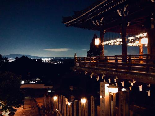 a night view of a chinese building with lights at THE KAKU Exclusive suite & Residence in Nara