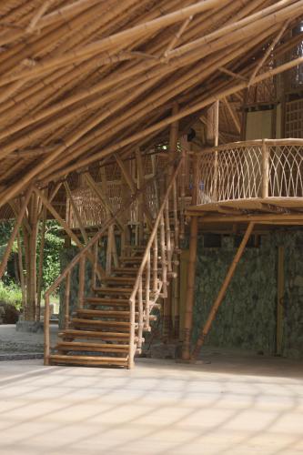 a wooden staircase in a building with wooden beams at Kiao Beach in Anepahan