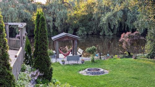 a backyard with a gazebo and a swing at Niagara Creekside B&B - Waterfront suite in Niagara Falls