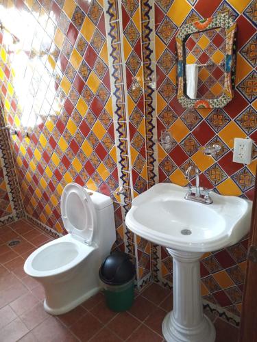 a bathroom with a toilet and a sink at hotel rio mar in Puerto Vallarta