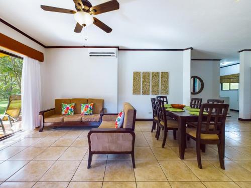 a living room with a ceiling fan and a table and chairs at Catalina Cove 3- 6 Bedroomloft Home in Brasilito