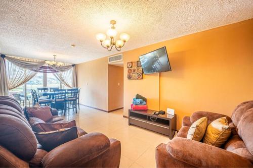 a living room with couches and a flat screen tv at 2-17 Jaco Beach Beautiful Costa Linda Condo in Jacó