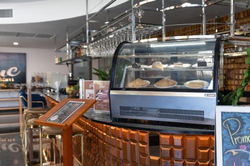 a bakery with a display case with pastries in it at The Blue Mavi Hotel in Chalong 