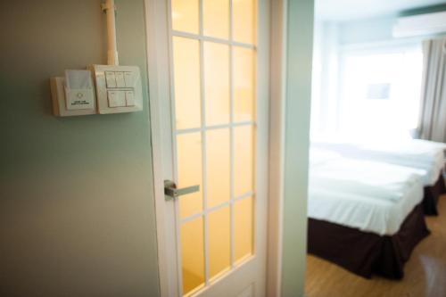 a door leading to a bedroom with a bed at KENCOZY accommodation in Bangkok