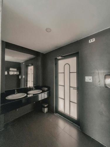 a bathroom with two sinks and a large window at Ly Ky Hotel in Quy Nhon