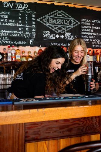 two women standing at a bar with drinks at Summer House Melbourne in Melbourne