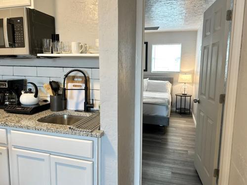 a kitchen with a sink and a bed in a room at Affordable Okc 1br Walk To Paseo Arts #20b in Oklahoma City