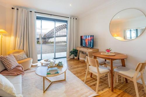 a living room with a table and a mirror at Best Harbour Views & location in Sydney in Sydney