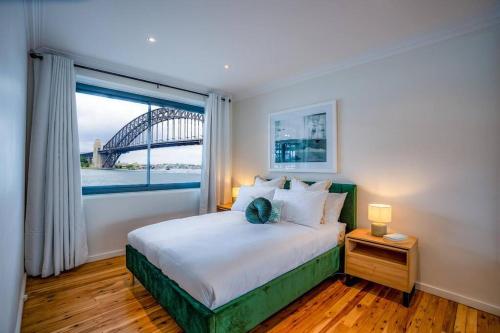 a bedroom with a bed with a view of a bridge at Best Harbour Views & location in Sydney in Sydney