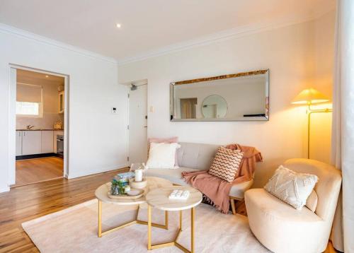 a living room with a couch and a table at Best Harbour Views & location in Sydney in Sydney