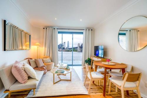 a living room with a couch and a table at Best Harbour Views & location in Sydney in Sydney