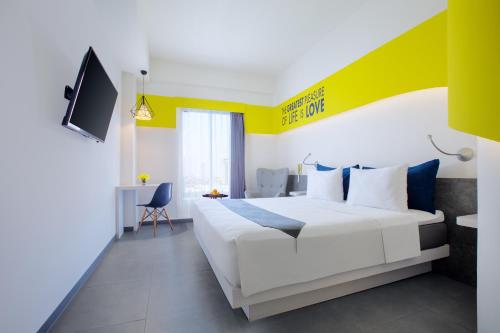 Postel nebo postele na pokoji v ubytování Yello Hotel Jemursari