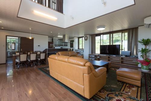 a large living room with a couch and a table at Comfort House In Miyakojima in Miyako-jima