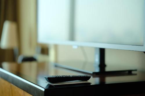 a glass counter top with a remote control on it at DoubleTree by Hilton Shanghai Pudong - Present welcome cookie in Shanghai