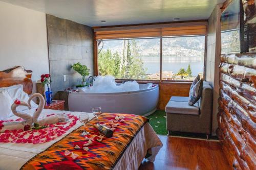 a bedroom with a bath tub and a bed and a tub at Hospedaje Campo Lago y Glamping in Otavalo