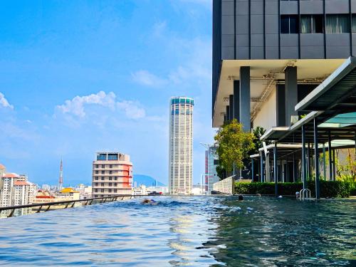 a view of a river in a city with buildings at Tropicana 218 Macalister by NGN in George Town