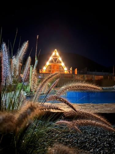 a house at night with lights in the background at Las Alpinas del vallee in Talca
