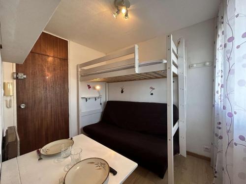 Cette petite chambre comprend des lits superposés et une table. dans l'établissement Studio à 20m de la plage avec parking, Saint-Jean-de-Monts - FR-1-224C-329, à Saint-Jean-de-Monts