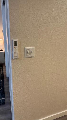 a beige wall with a light switch on it at A luxury studio apartment, in Salt Lake City