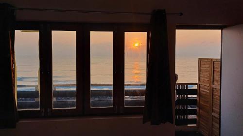 a view of the ocean from a window at DIVINE BEACH INN - The sea shore hotel in Puducherry