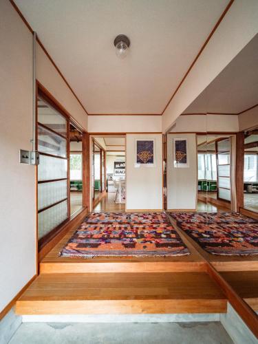 a large room with a rug on the floor at 網ノ屋 - Aminoya Beach House Ezura in Shirahama