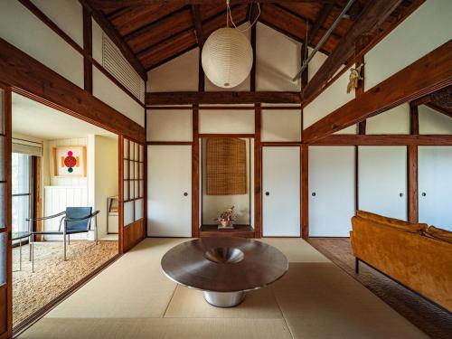 a living room with a table and a couch at 網ノ屋 - Aminoya Beach House Ezura in Shirahama