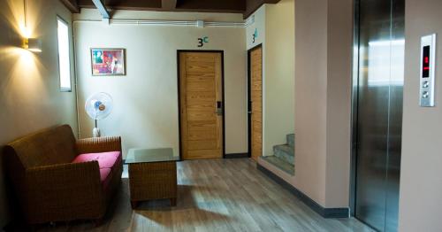 a living room with a couch and a door at KENCOZY accommodation in Bangkok