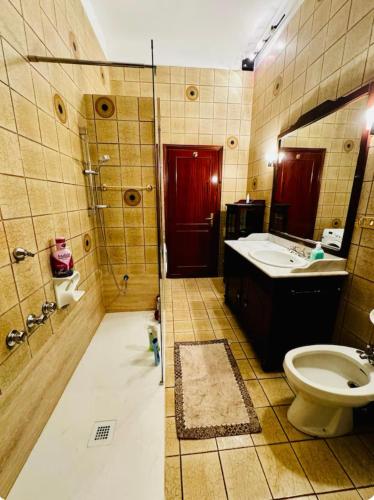 a bathroom with a toilet and a sink and a mirror at Bnb fantasia in Bologna