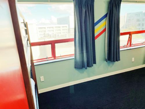 a room with a window with a rainbow on it at United Auckland in Auckland