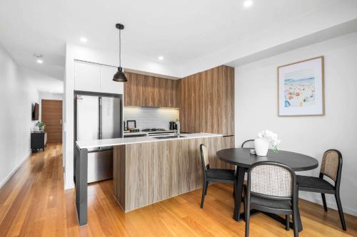 a kitchen and dining room with a table and chairs at 2BR Torquay Gem in Torquay