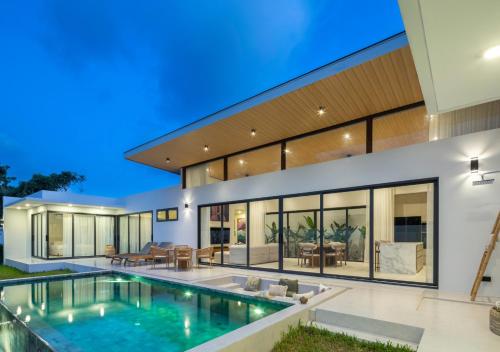 an exterior view of a house with a swimming pool at Villa Amour 3 Bedroom Spa Pool Retreat near Beach - Lamai in Lamai