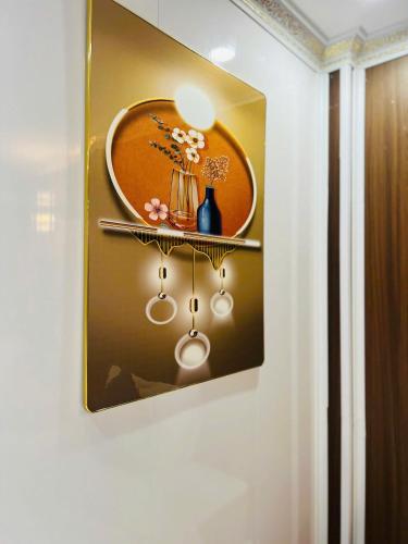 a painting of a plate on a wall with a shelf at Sapa Grand Blue Hotel in Sa Pa