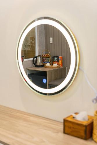 a mirror on a white wall with a counter with a table at Hanhhome in Ho Chi Minh City