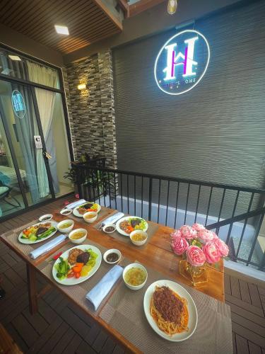 a wooden table with plates of food on it at Hanhhome in Ho Chi Minh City