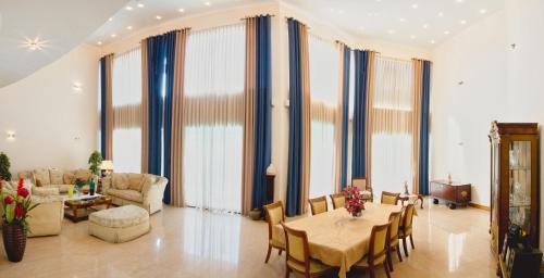 a living room with a table and chairs at Villa 53 in Battaramulla
