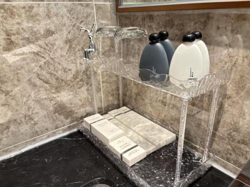 a shelf with two vases on it in a bathroom at TheBess Hotel Tokyo is located adjacent to Singapore and offers a sea viewIt is a family business smart room with the sea view of Princess Bay富力公主湾 in Johor Bahru