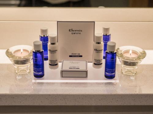 a display of essential oils and candles on a counter at PREMIER SUITES Dublin, Ballsbridge in Dublin