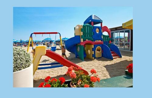 a playground on the beach with a slide at Hotel Arno in Misano Adriatico