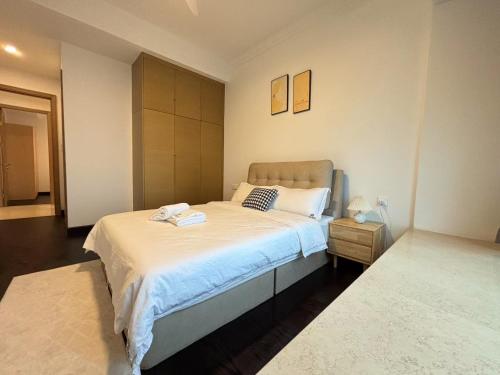 a bedroom with a large bed with white sheets at TheBess Hotel Tokyo is located adjacent to Singapore and offers a sea viewIt is a family business smart room with the sea view of Princess Bay富力公主湾 in Johor Bahru