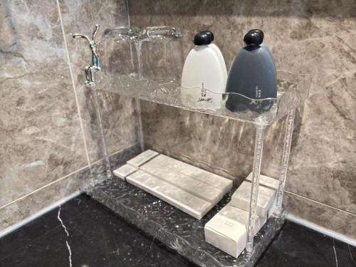 a bathroom with a shelf with two vases on it at TheBess Hotel Tokyo is located adjacent to Singapore and offers a sea viewIt is a family business smart room with the sea view of Princess Bay富力公主湾 in Johor Bahru